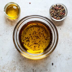 Homemade balsamic dressing ingredients in a jar before shaking.