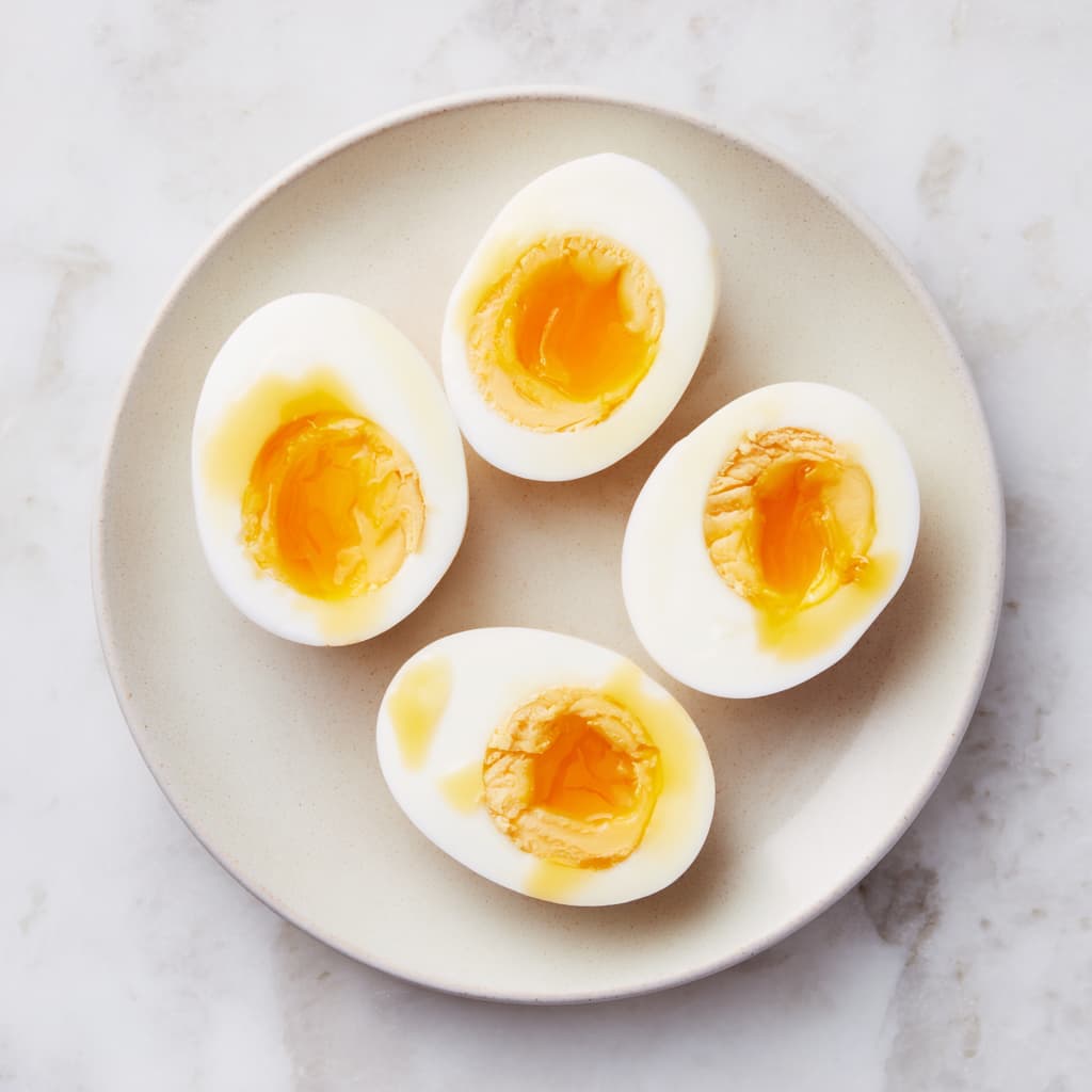 Soft boiled eggs sliced in half for a high protein breakfast bowl