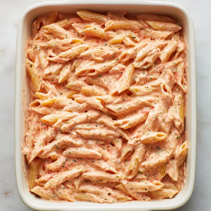 Unbaked cottage cheese pasta bake topped with mozzarella and parmesan cheese