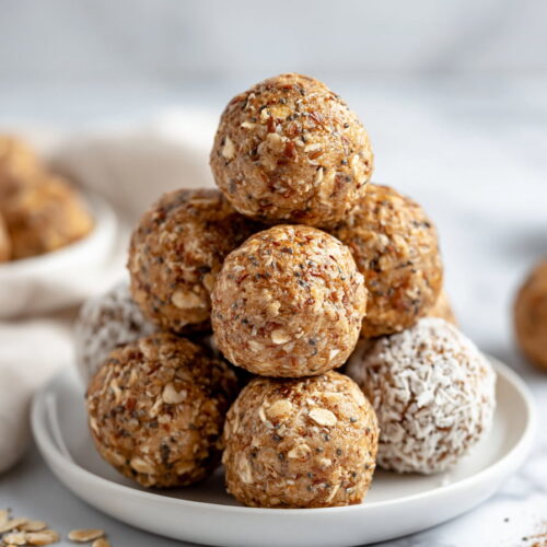Cinnamon roll energy balls served on a plate with coconut coating and oat texture visible