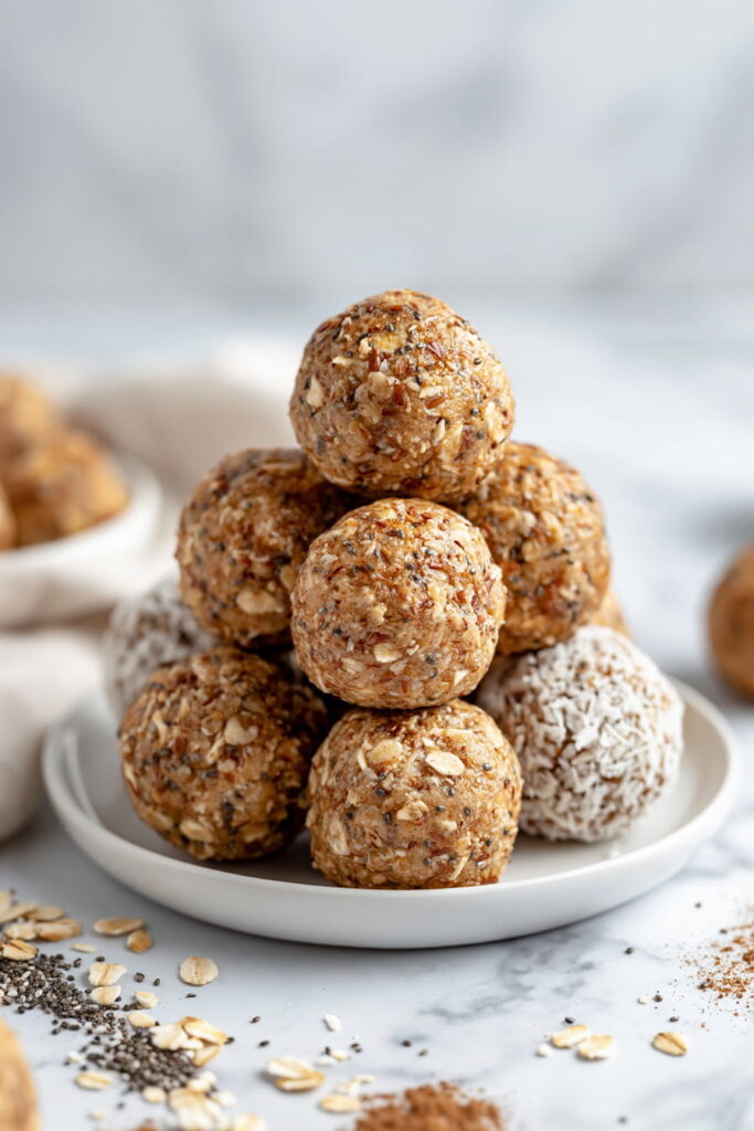 Cinnamon roll energy balls served on a plate with coconut coating and oat texture visible