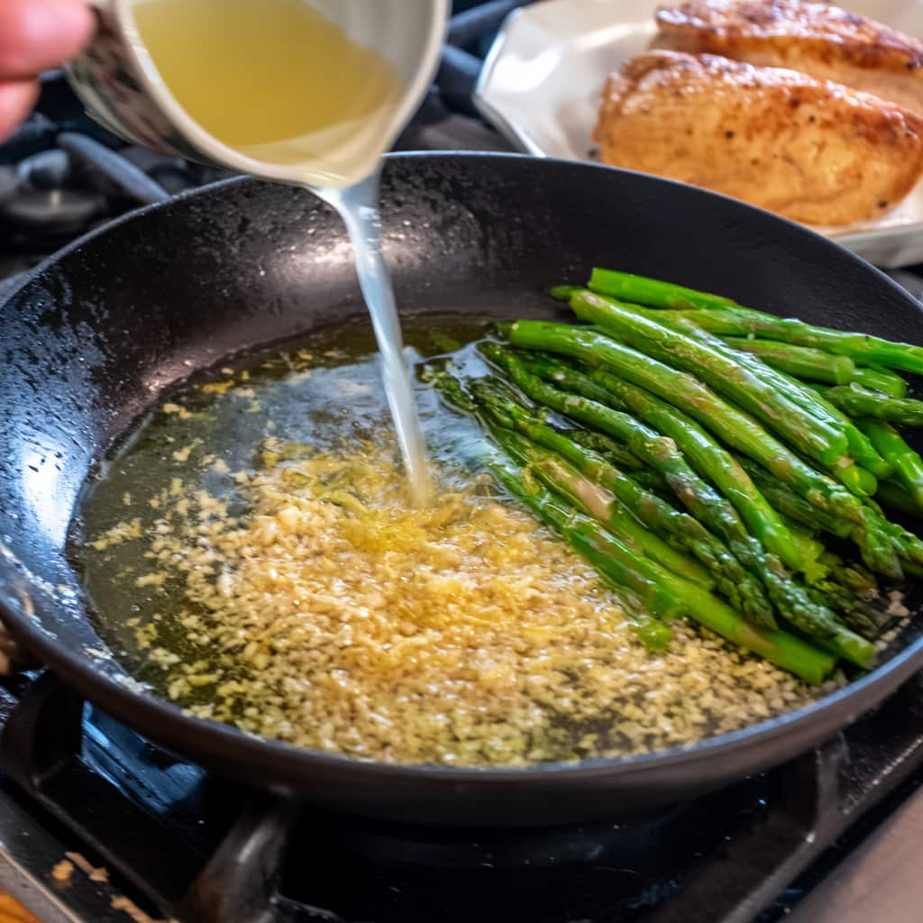 Garlic, lemon juice, zest and broth added to skillet creating a light sauce