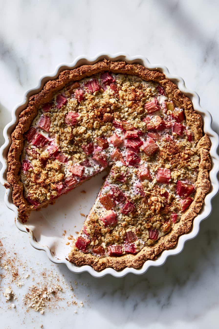 Healthy rhubarb protein pie with oat crust and creamy rhubarb filling served on a plate.
